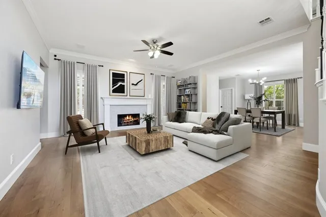 a living room with furniture fireplace and flat screen tv