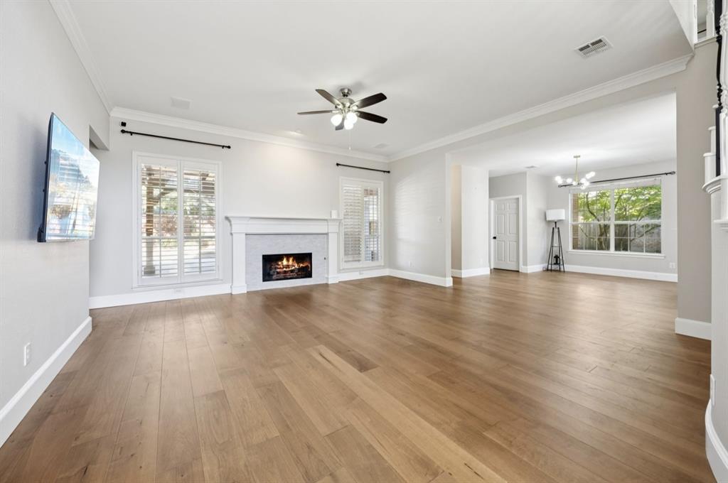 7913 Morningdew Drive Plano, TX 75025 - Photo 17 of 40 a view of an empty room with wooden floor and a window