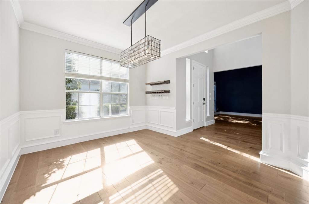 7913 Morningdew Drive Plano, TX 75025 - Photo 22 of 40 a view of an empty room with a window and wooden floor