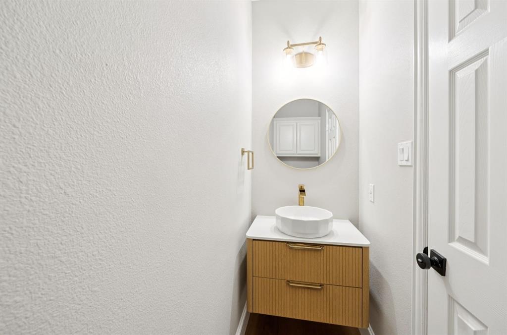 7913 Morningdew Drive Plano, TX 75025 - Photo 25 of 40 a bathroom with a sink and a mirror