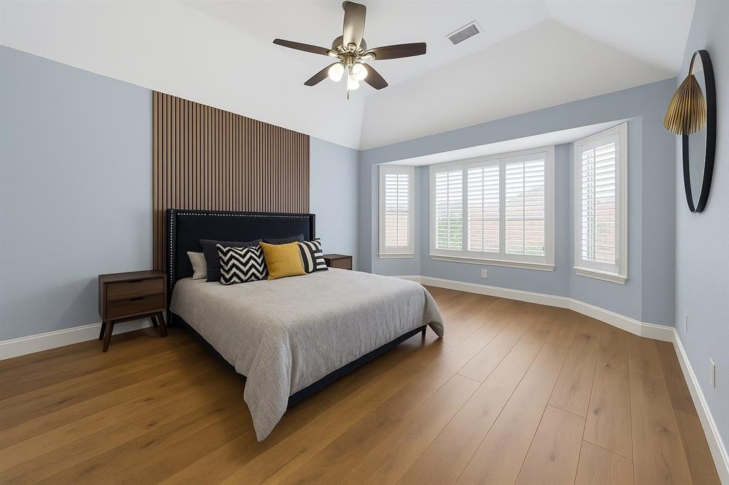 7913 Morningdew Drive Plano, TX 75025 - Photo 26 of 40 a bedroom with a bed chandelier and a window