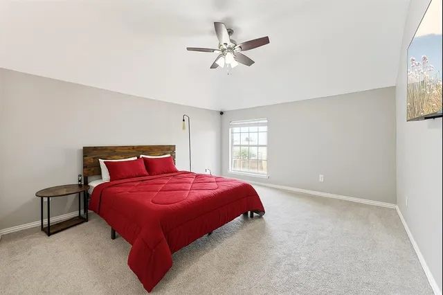 a bedroom with a bed and window