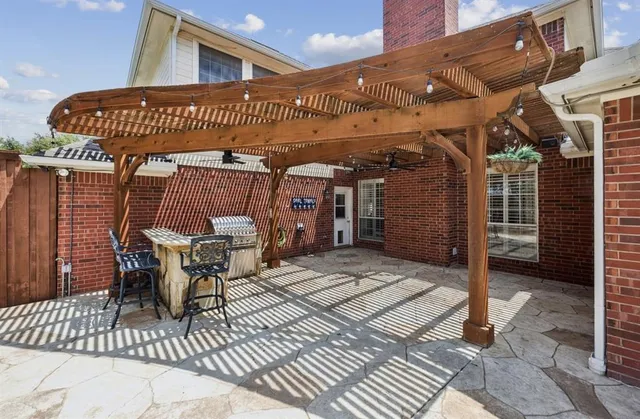 a view of a patio with table and chairs with wooden floor