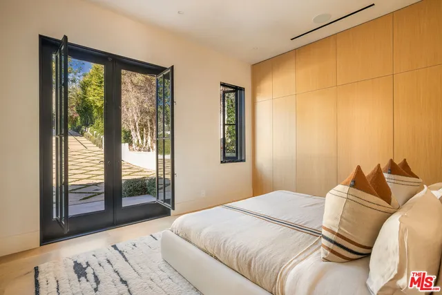 a bathroom with a granite countertop sink a mirror and shower
