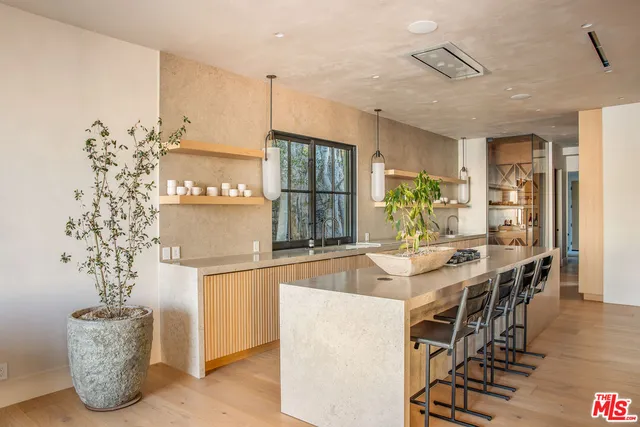 a living room with couches and a flat screen tv