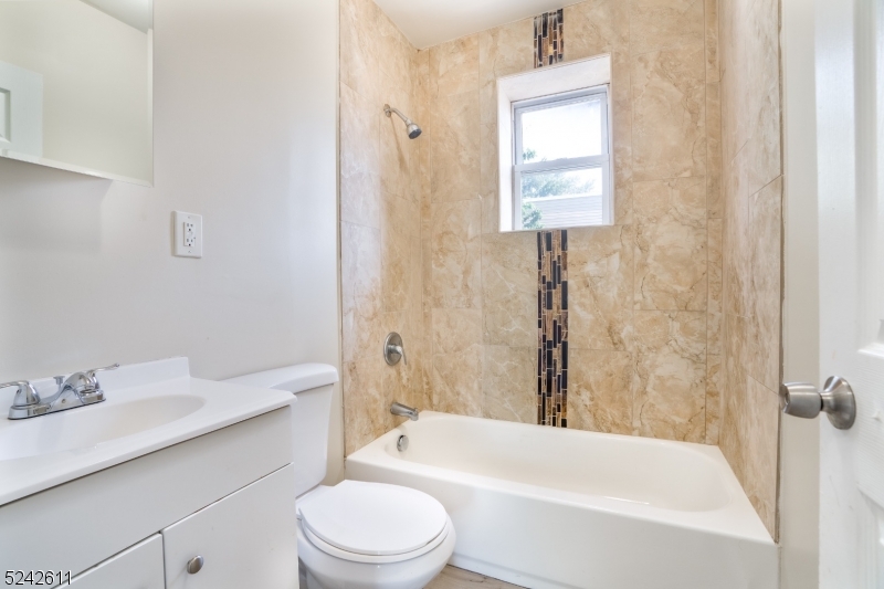 473 South 16th Street, Unit 2 Newark, NJ 07103 - Photo 12 of 15 a bathroom with a sink toilet vanity and bathtub