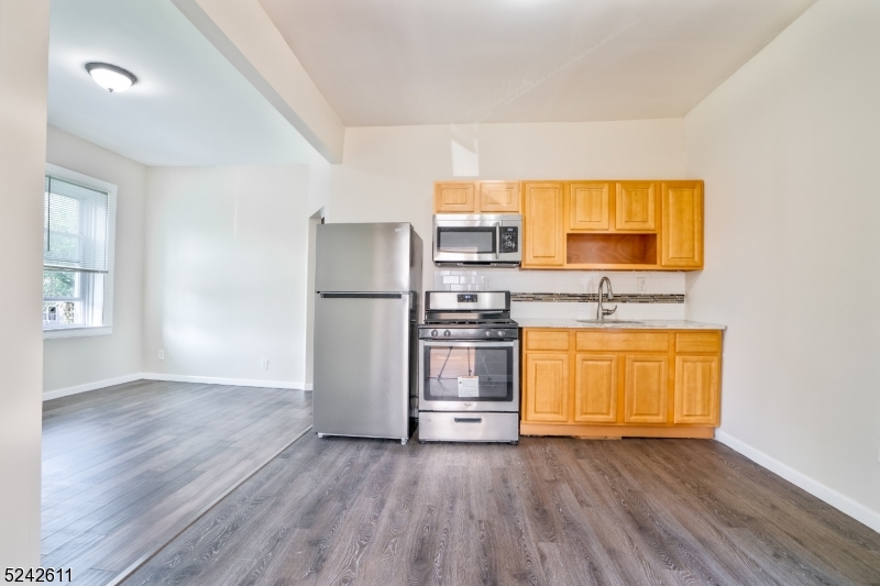 473 South 16th Street, Unit 2 Newark, NJ 07103 - Photo 2 of 15 a view of kitchen with wooden floor and electronic appliances
