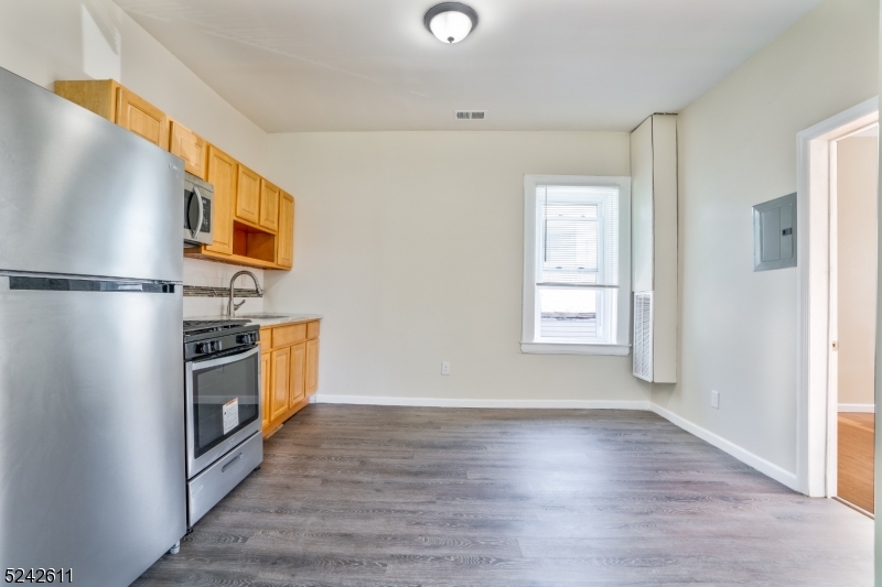 473 South 16th Street, Unit 2 Newark, NJ 07103 - Photo 3 of 15 a kitchen with stainless steel appliances a refrigerator and a window