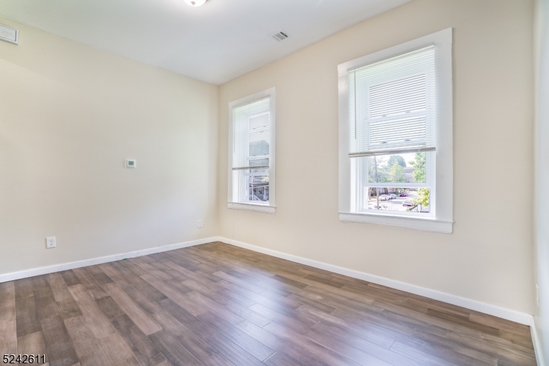 473 South 16th Street, Unit 2 Newark, NJ 07103 - Photo 4 of 15 an empty room with wooden floor and windows