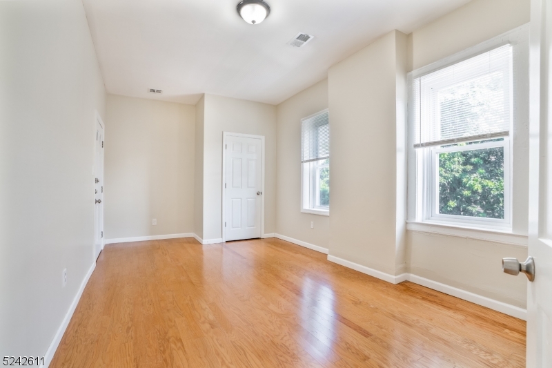 473 South 16th Street, Unit 2 Newark, NJ 07103 - Photo 5 of 15 an empty room with windows