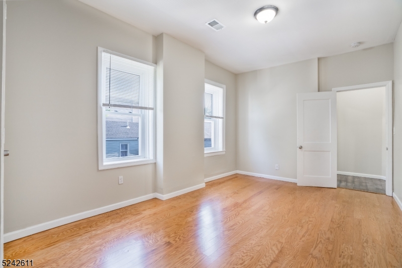 473 South 16th Street, Unit 2 Newark, NJ 07103 - Photo 6 of 15 an empty room with windows and closet