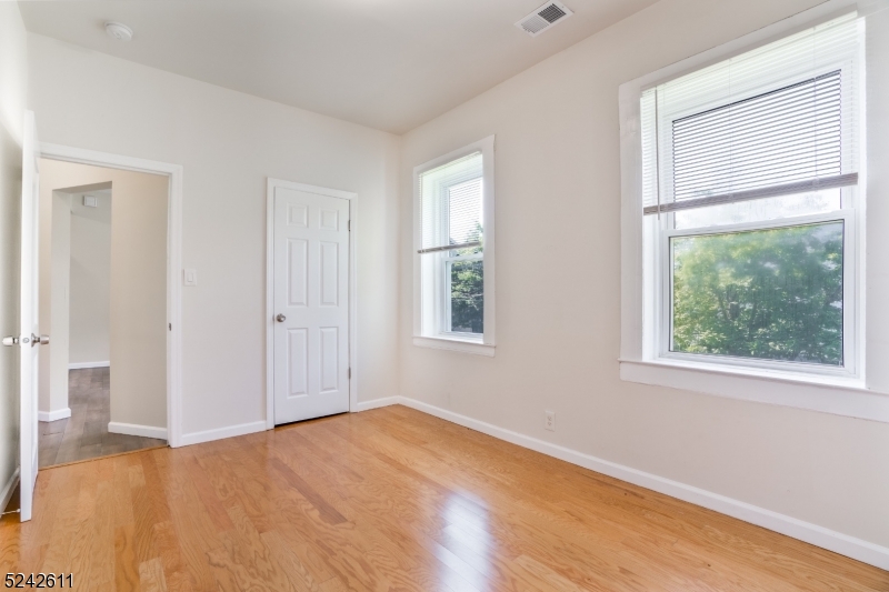 473 South 16th Street, Unit 2 Newark, NJ 07103 - Photo 8 of 15 a view of empty room with wooden floor and fan