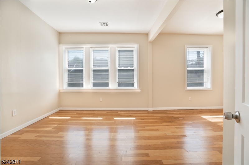473 South 16th Street, Unit 2 Newark, NJ 07103 - Photo 9 of 15 a view of empty room with wooden floor and fan
