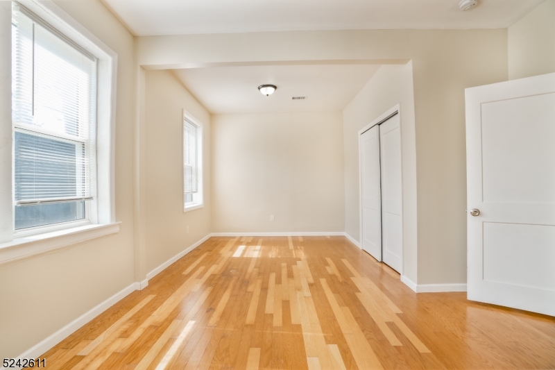 473 South 16th Street, Unit 2 Newark, NJ 07103 - Photo 10 of 15 a view of empty room with wooden floor and fan