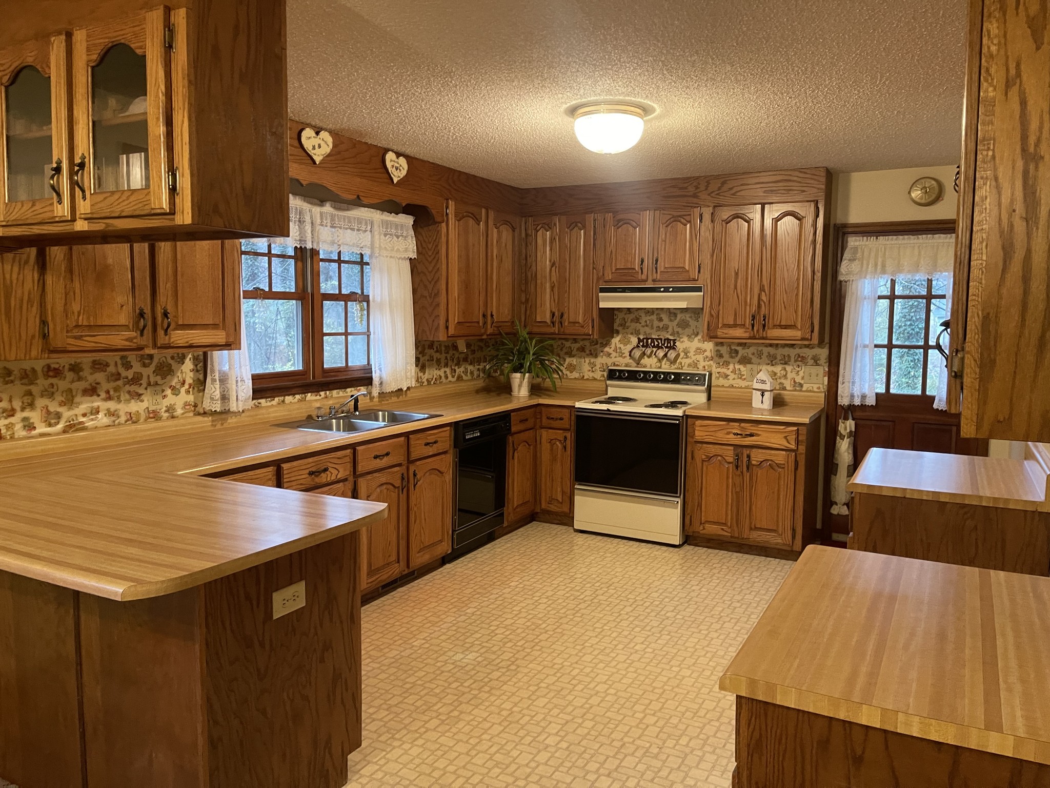 76 Shoally Branch Road Leoma, TN 38468 - Photo 7 of 21 a kitchen with stainless steel appliances granite countertop a sink counter space and a large window