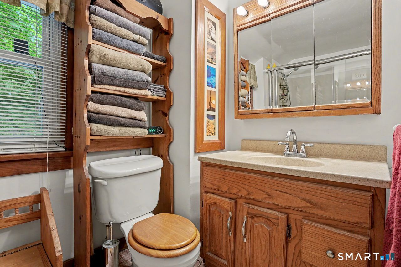 74 Maple Street Seymour, CT 06483 - Photo 27 of 40 a bathroom with a granite countertop toilet sink and mirror