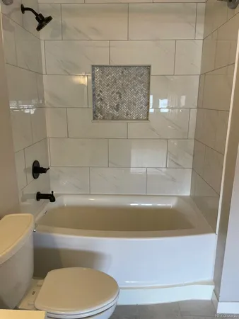 a bathroom with a bathtub and a toilet