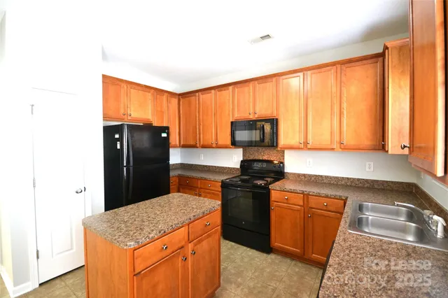a kitchen with a counter top space and a refrigerator
