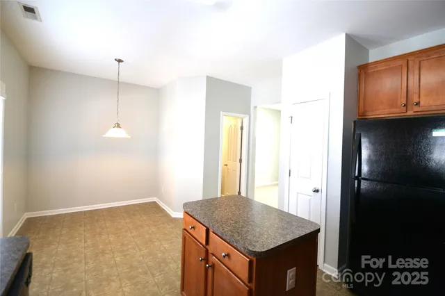 a kitchen with a sink a counter top space and cabinets