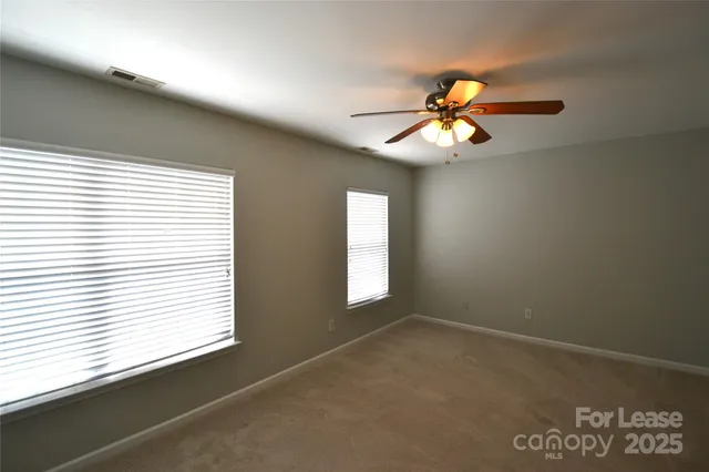 a view of a livingroom with a ceiling fan and window