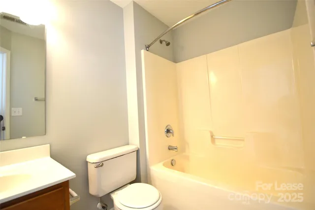 a bathroom with a sink toilet and mirror