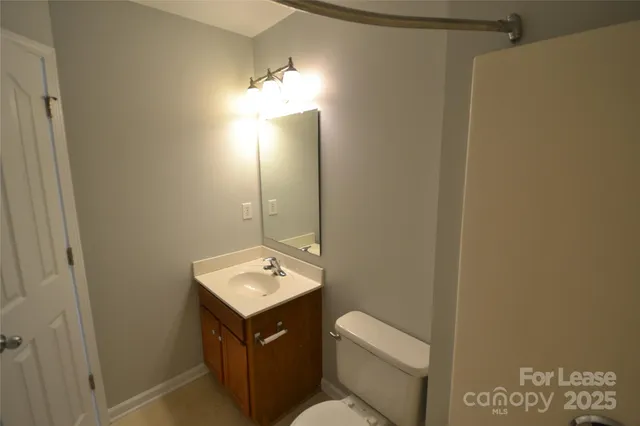 an empty room with closet and a chandelier fan