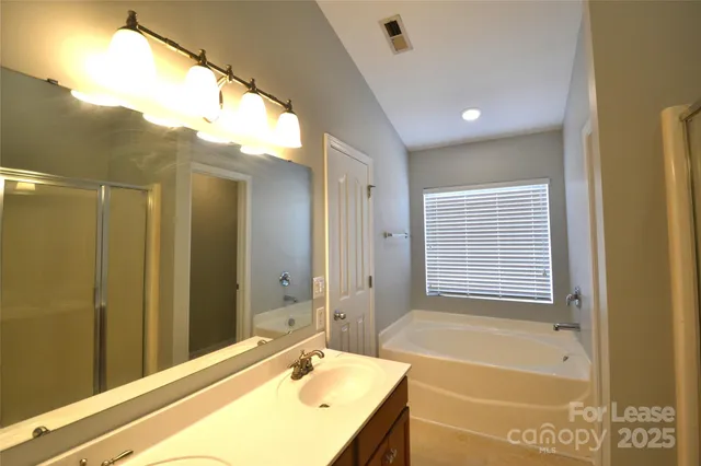 a bathroom with a bathtub and a shower