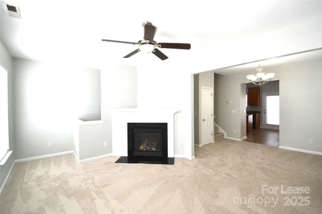 a view of empty room with a fireplace