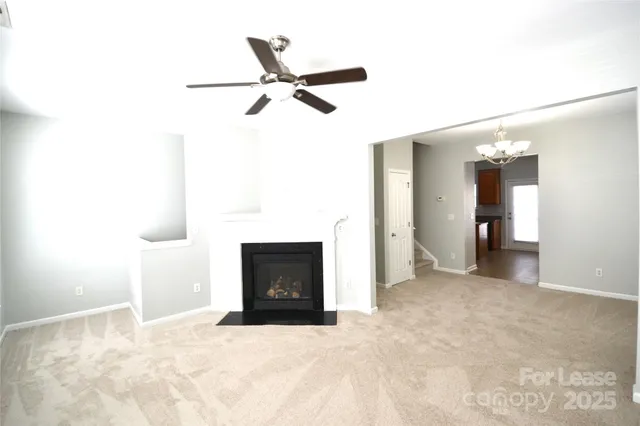 a view of empty room with window and fireplace
