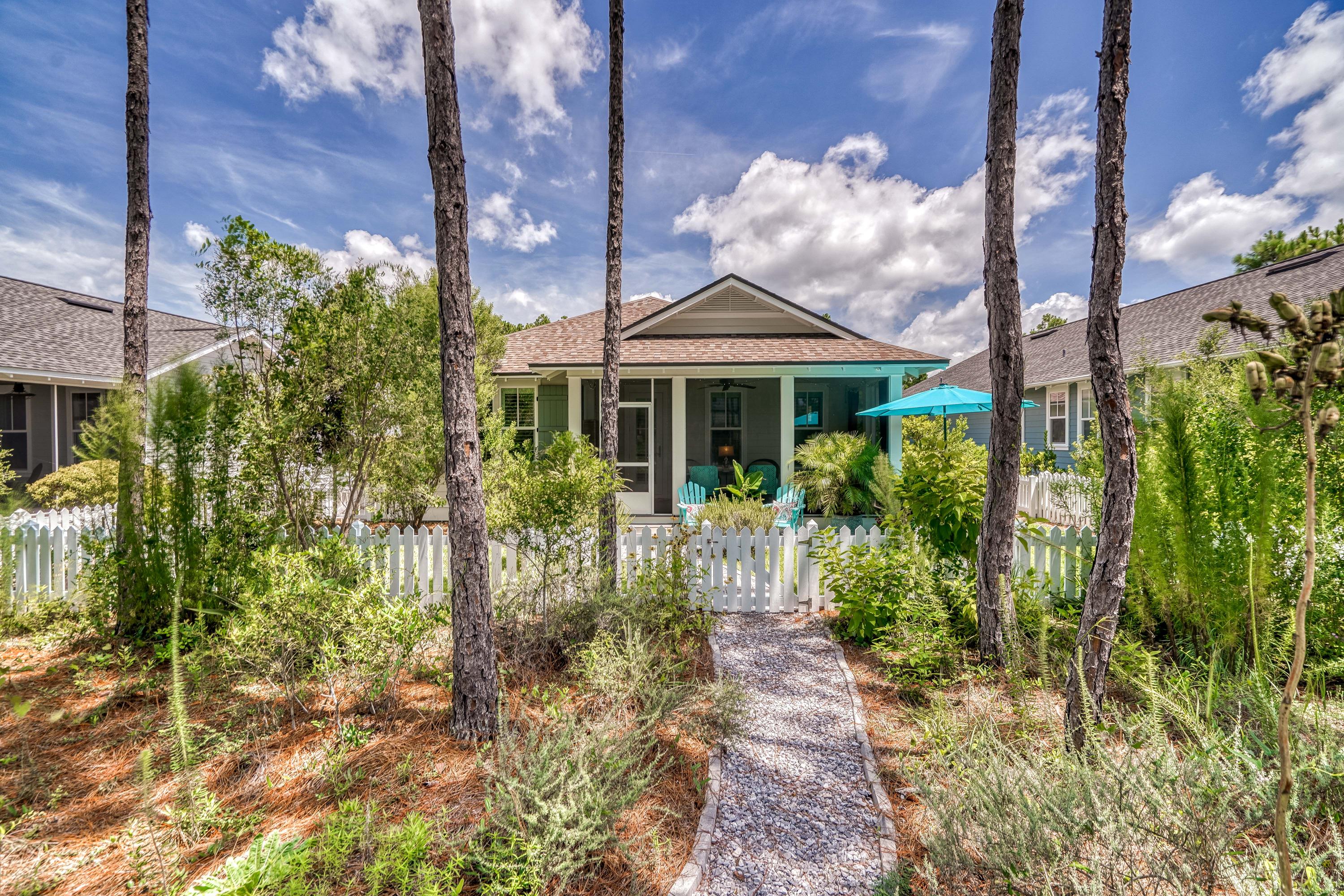 137 Jack Knife Drive Inlet Beach, FL 32461 - Photo 9 of 45 a view of a brick house with plants and large trees