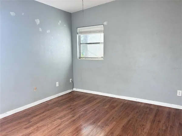 a view of a room with wooden floor and windows