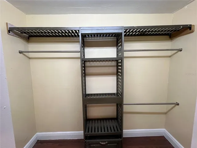 a view of walk in closet with empty racks