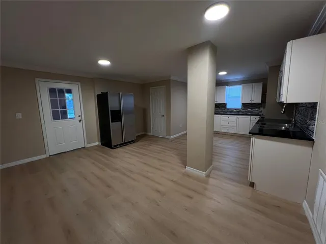 a view of a kitchen with a sink and a refrigerator