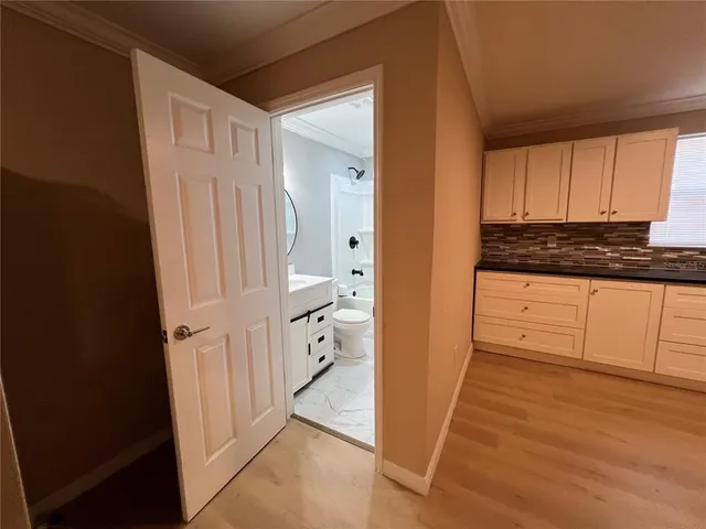 a view of a kitchen with wooden floor