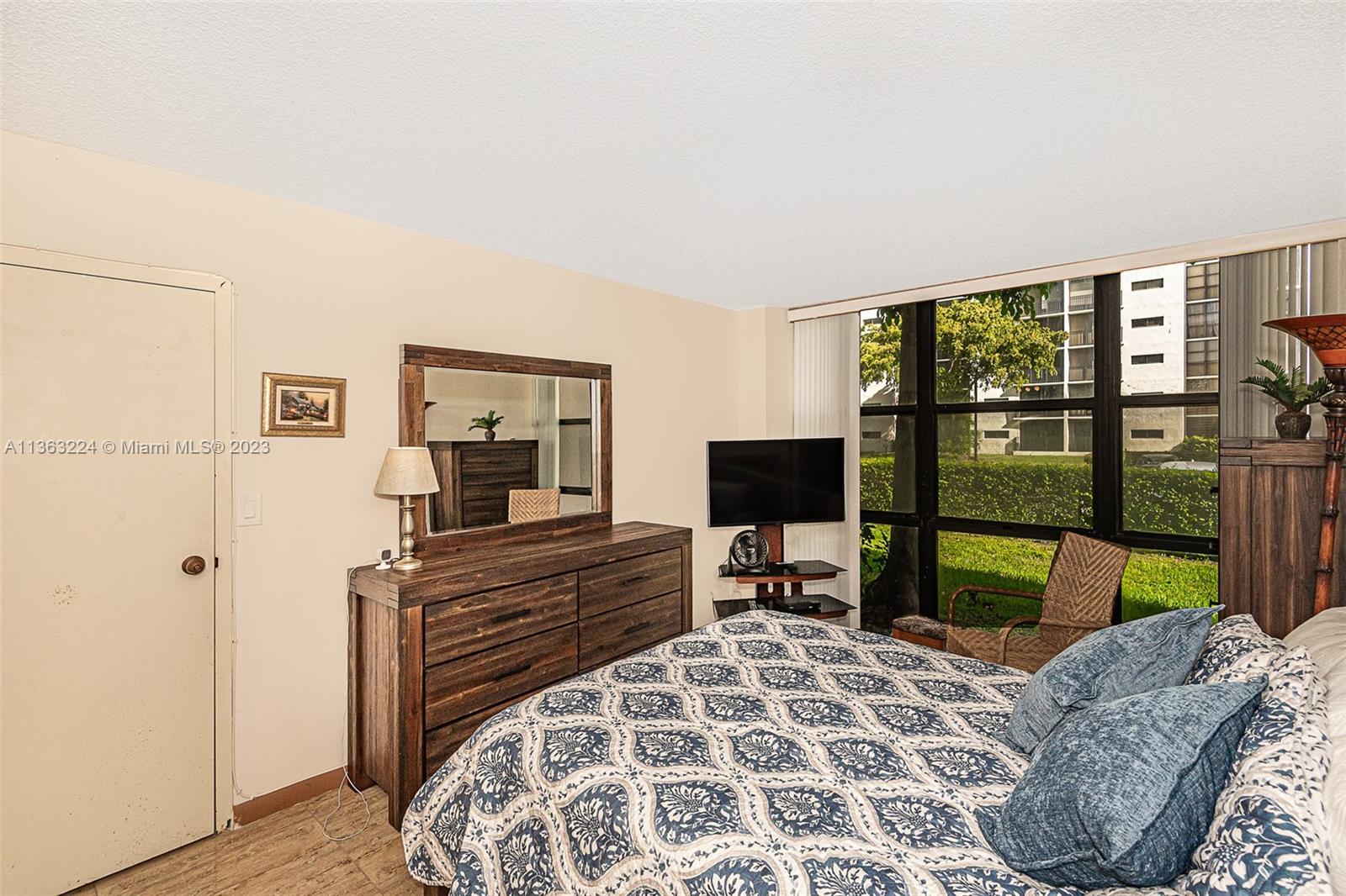 17011 North Bay Road, Unit 107 Sunny Isles Beach, FL 33160 - Photo 19 of 26 a bedroom with a bed and a window