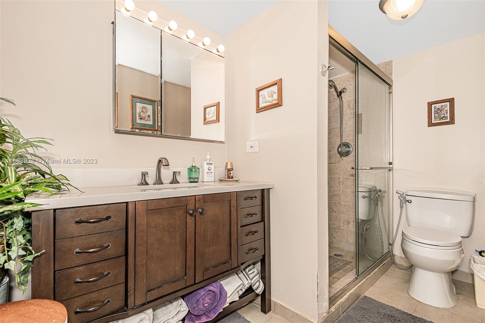 17011 North Bay Road, Unit 107 Sunny Isles Beach, FL 33160 - Photo 21 of 26 a spacious bathroom with a granite countertop sink mirror and toilet