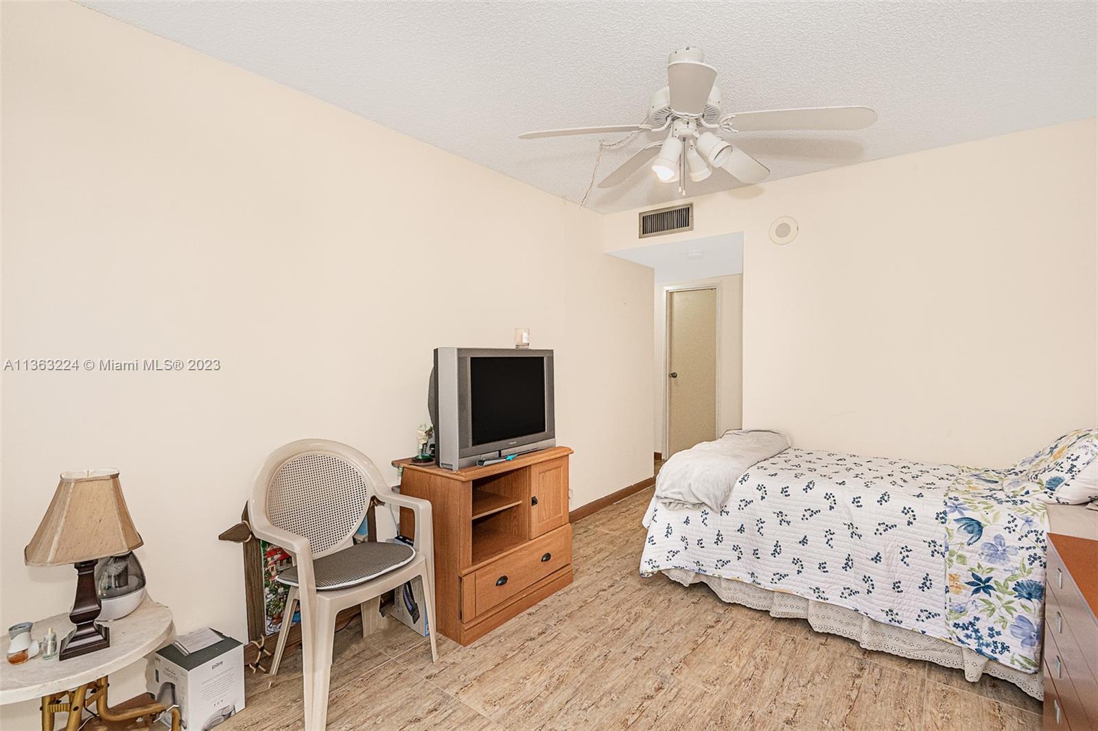 17011 North Bay Road, Unit 107 Sunny Isles Beach, FL 33160 - Photo 24 of 26 a bedroom with a bed and a flat screen tv