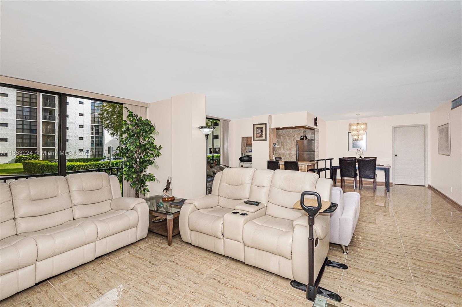 17011 North Bay Road, Unit 107 Sunny Isles Beach, FL 33160 - Photo 4 of 26 a living room with furniture and large windows