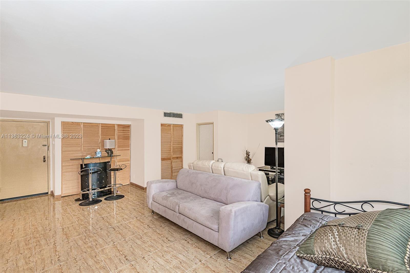 17011 North Bay Road, Unit 107 Sunny Isles Beach, FL 33160 - Photo 7 of 26 a living room with furniture