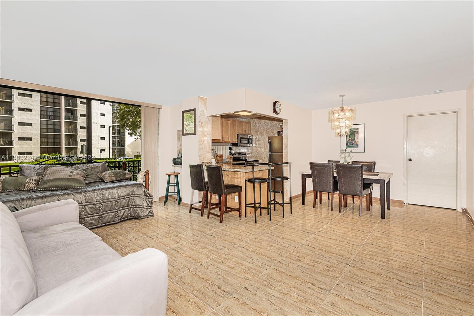 17011 North Bay Road, Unit 107 Sunny Isles Beach, FL 33160 - Photo 8 of 26 a living room with furniture and a large window