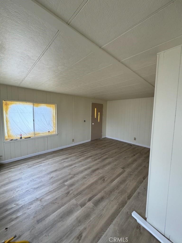 218 Park Way Bodfish, CA 93205 - Photo 11 of 13 an empty room with wooden floor and windows