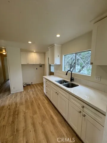 a large kitchen with a sink and cabinets