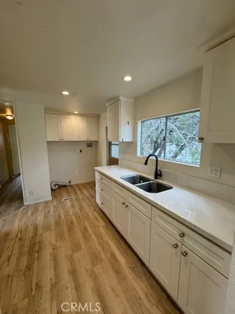 a large kitchen with a sink and cabinets