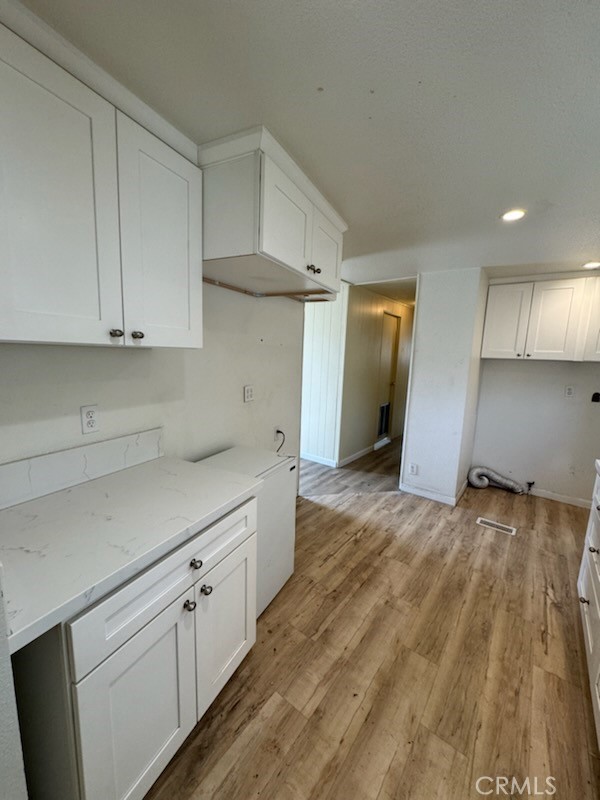 218 Park Way Bodfish, CA 93205 - Photo 6 of 13 a view of a kitchen with white cabinets and wooden floor