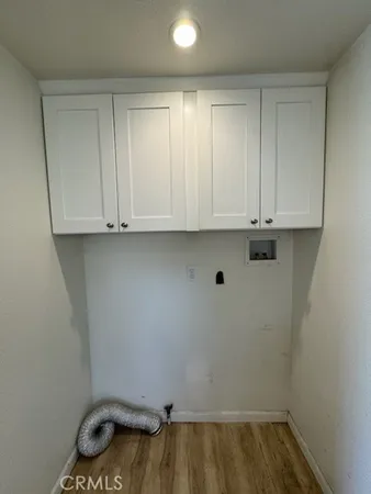 a view of storage and utility room with wooden floor