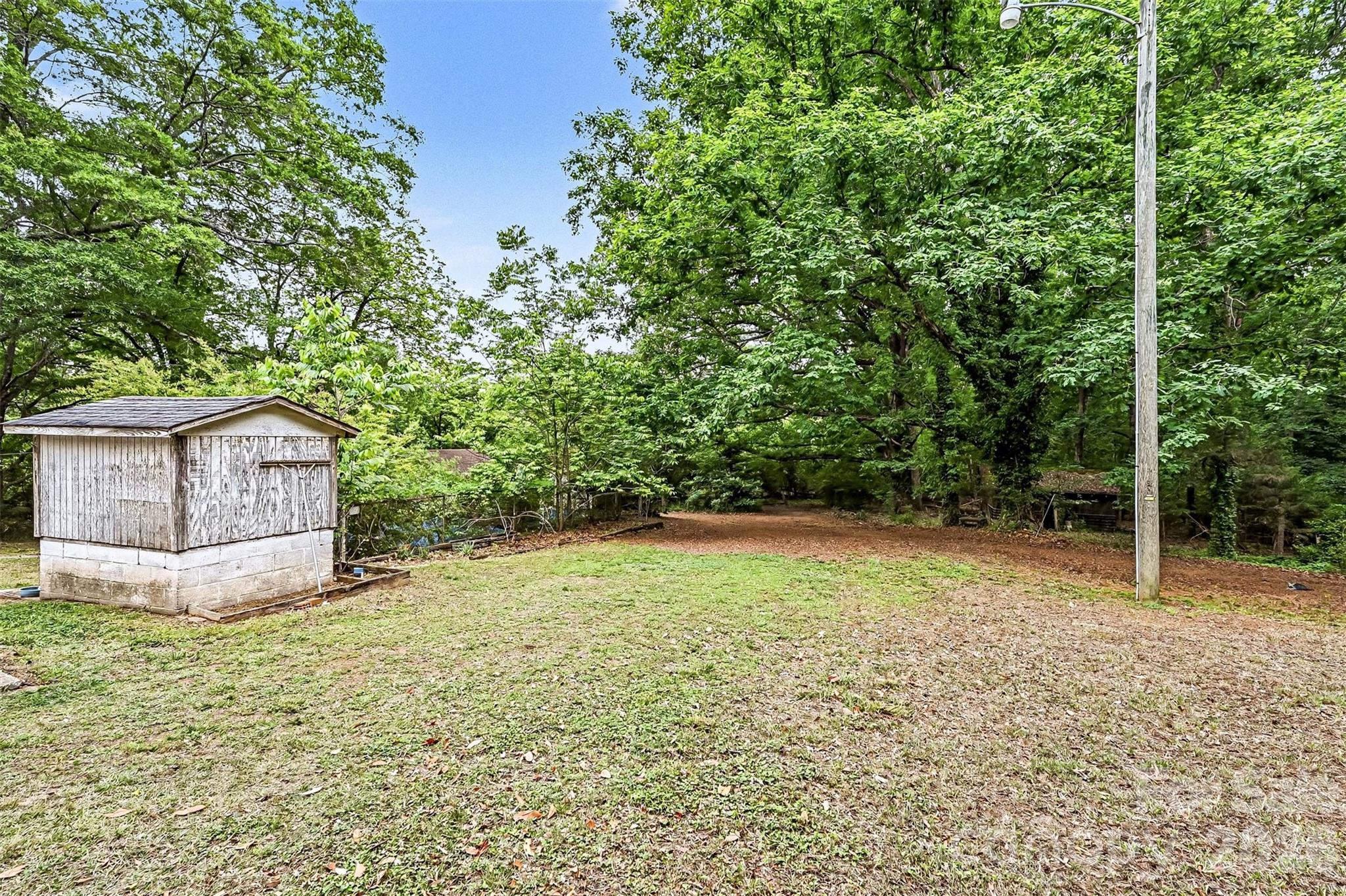 1116 Medlin Road Monroe, NC 28112 - Photo 29 of 40 a house with trees in the background