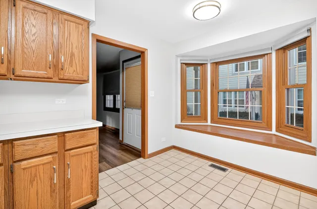 a view of a kitchen with wooden floor and cabinets