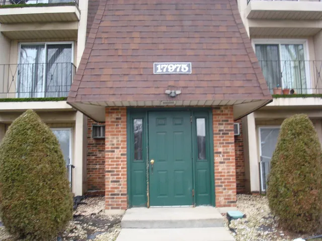 a view of a brick house with a large windows