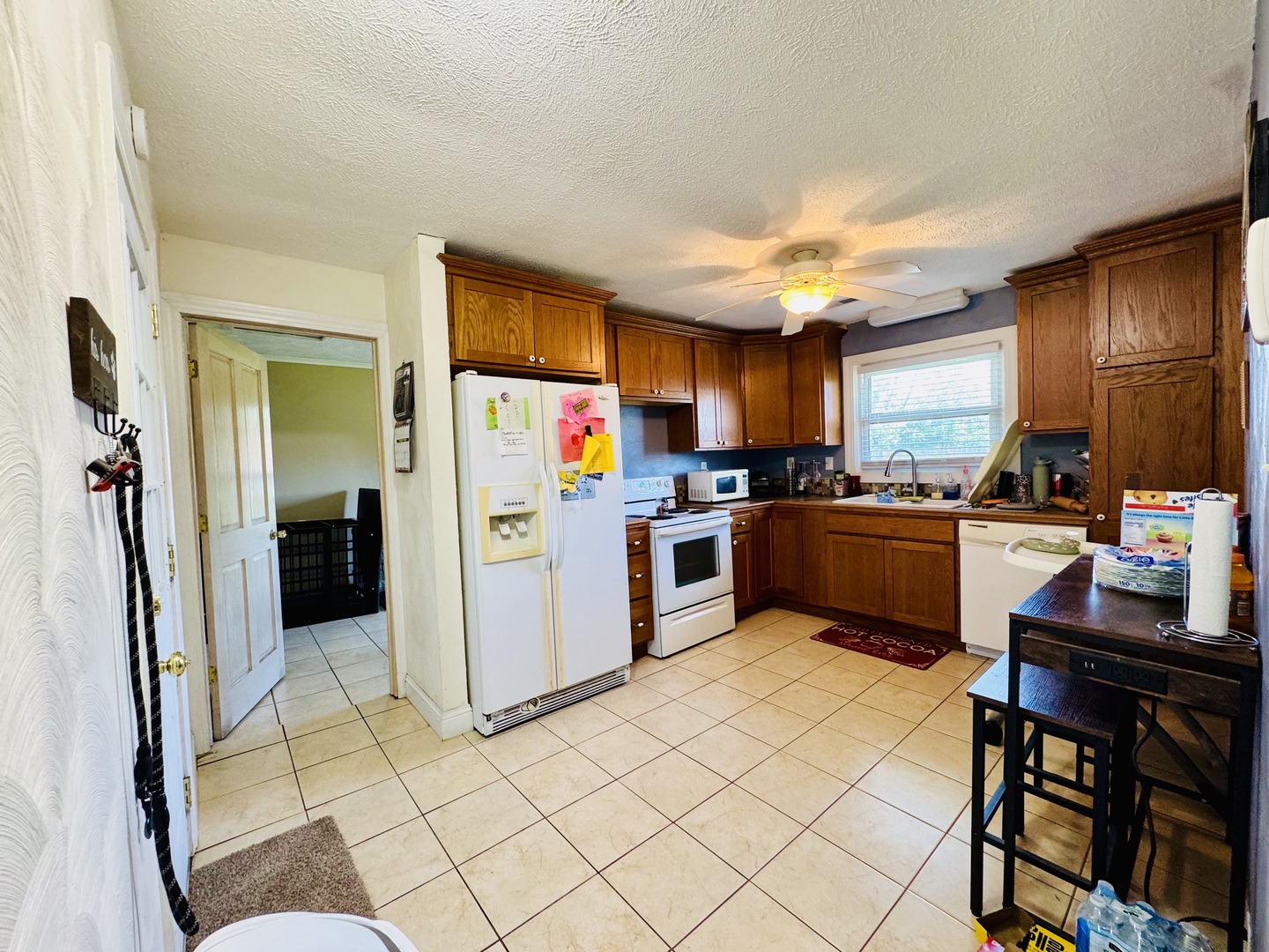 203 West Callie Street Sesser, IL 62884 - Photo 15 of 27 a kitchen with stainless steel appliances kitchen island granite countertop a refrigerator and a stove top oven
