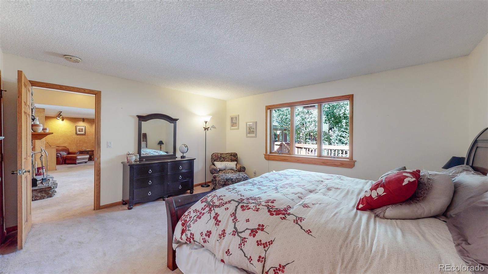 2720 South Spring Gulch Road Idaho Springs, CO 80452 - Photo 14 of 38 a bedroom with a bed and wooden floor